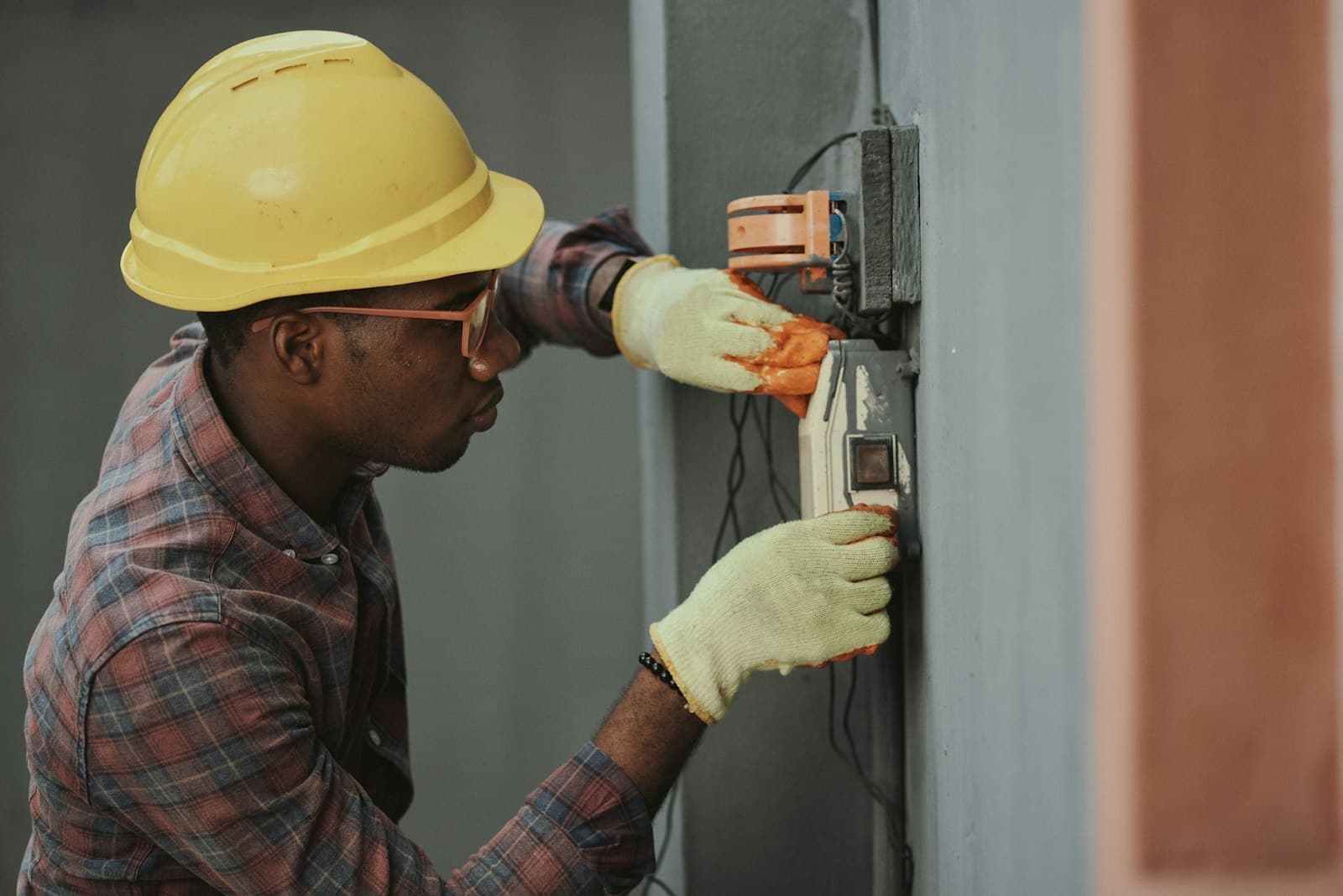 A technician working on an electrical panel